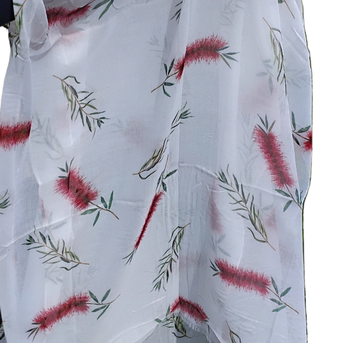 White scarf with red and green floral pattern.