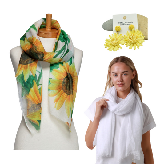 a yellow sunflower scarf on a mannequin, a lady wearing a plain white scarf and a pair of yellow flower raffia earrings on a decorate rock