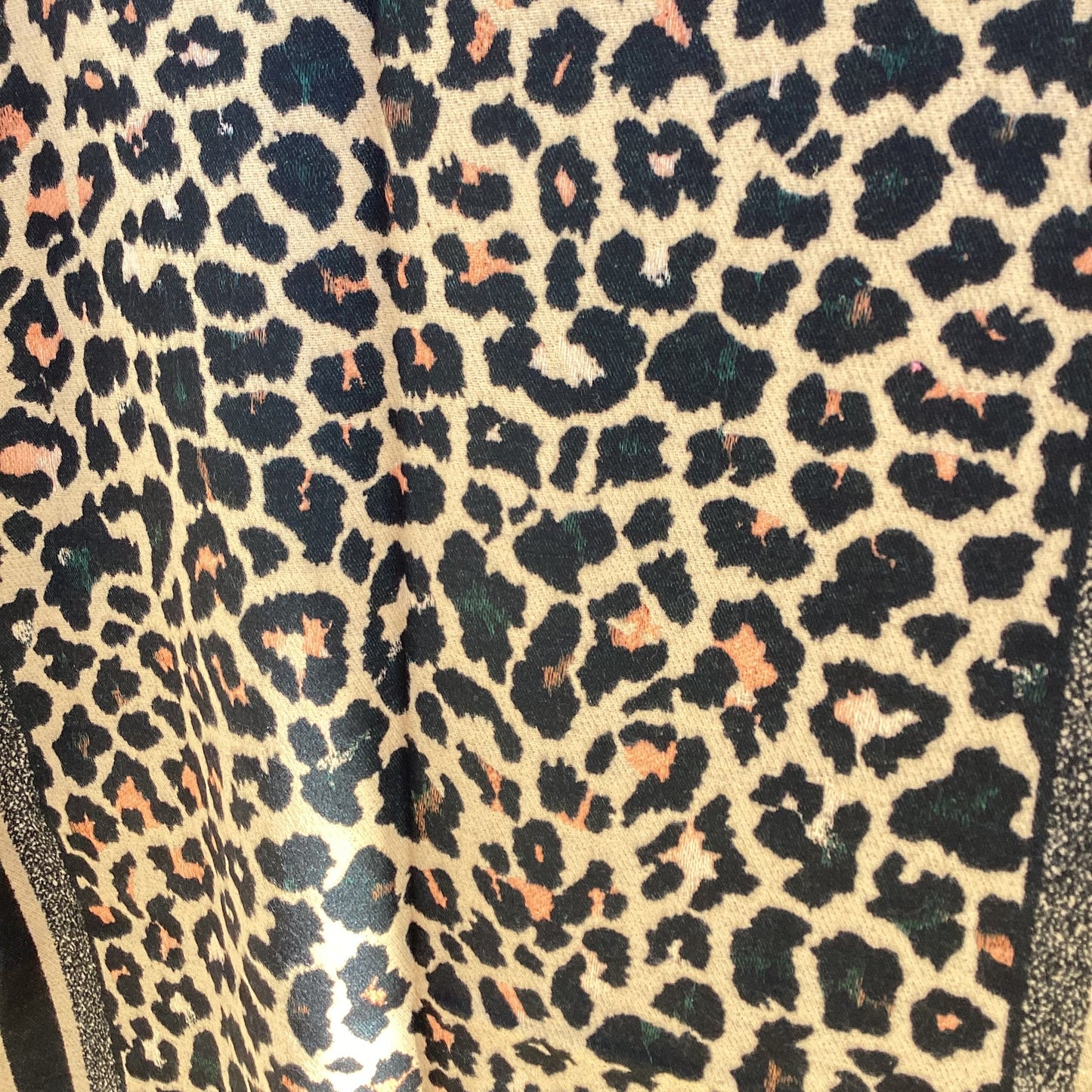 Close-up of leopard print ladies scarf with a beige background