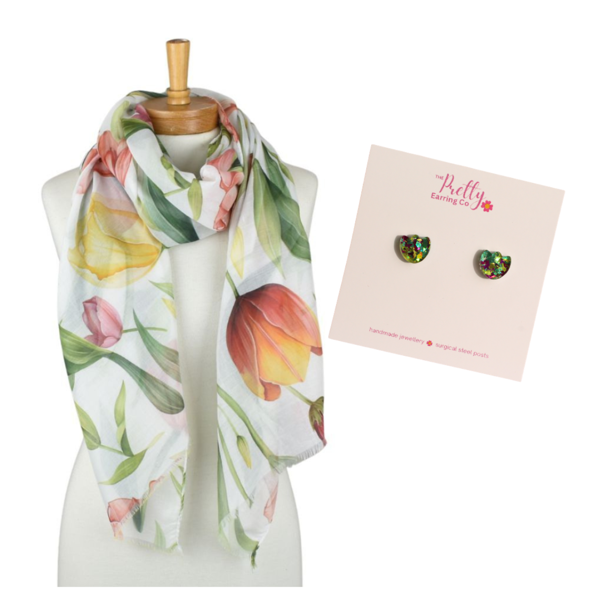 Floral scarf on a mannequin with a card featuring tulip earrings on a white background