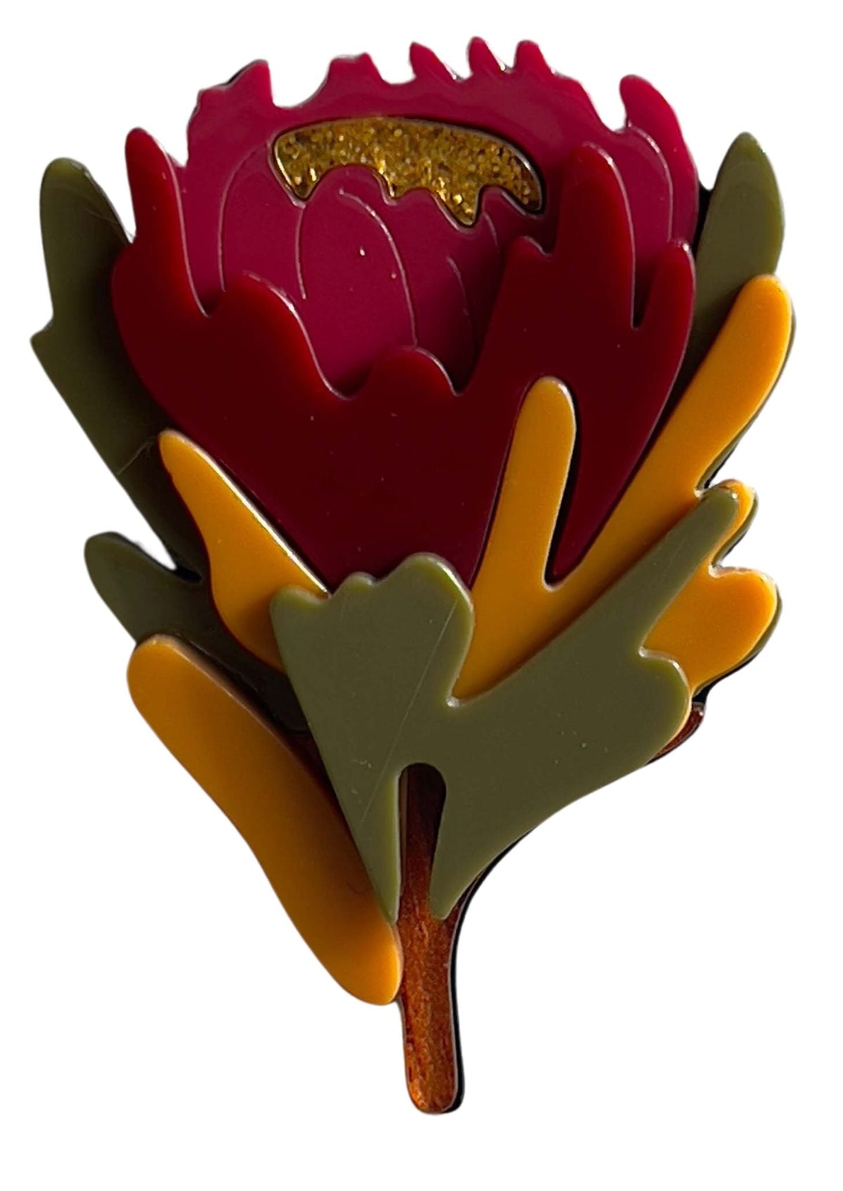 Colorful flower-shaped brooch with a white background
