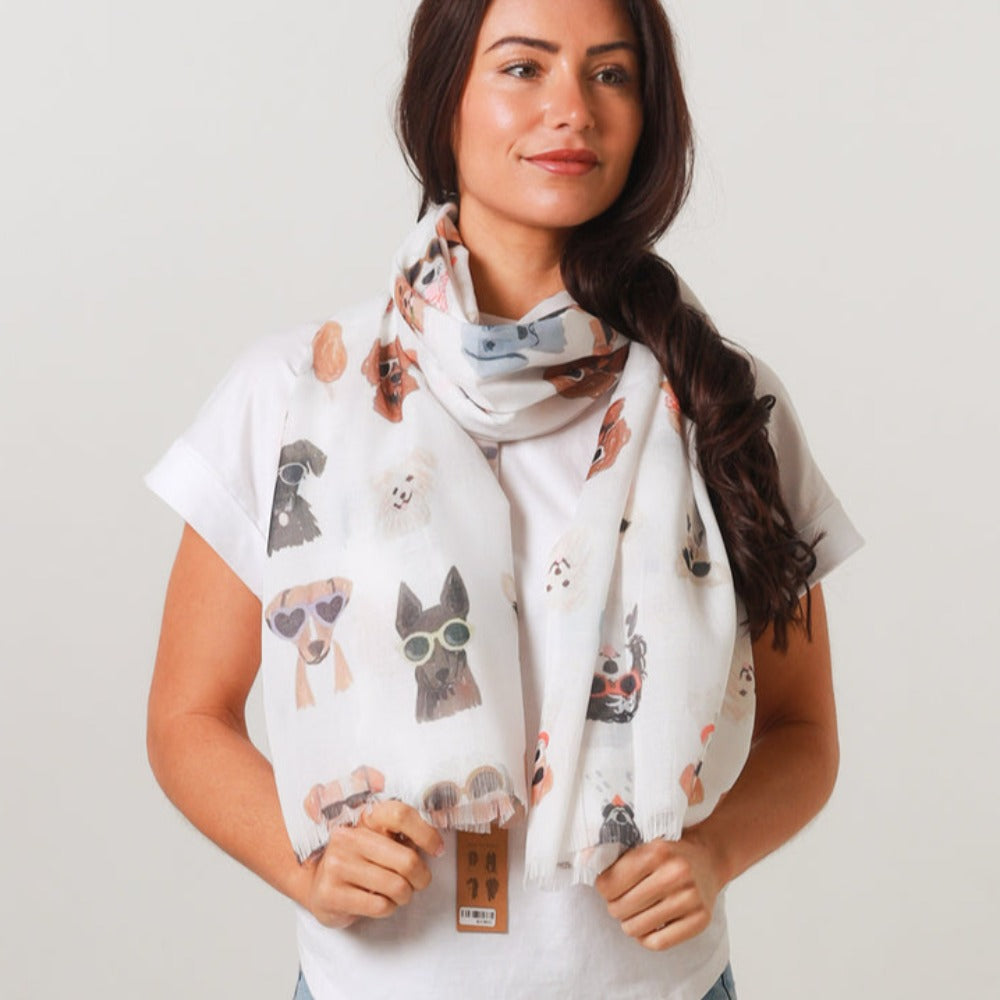 a lady wearing a white scarf that has a cute dog pattern