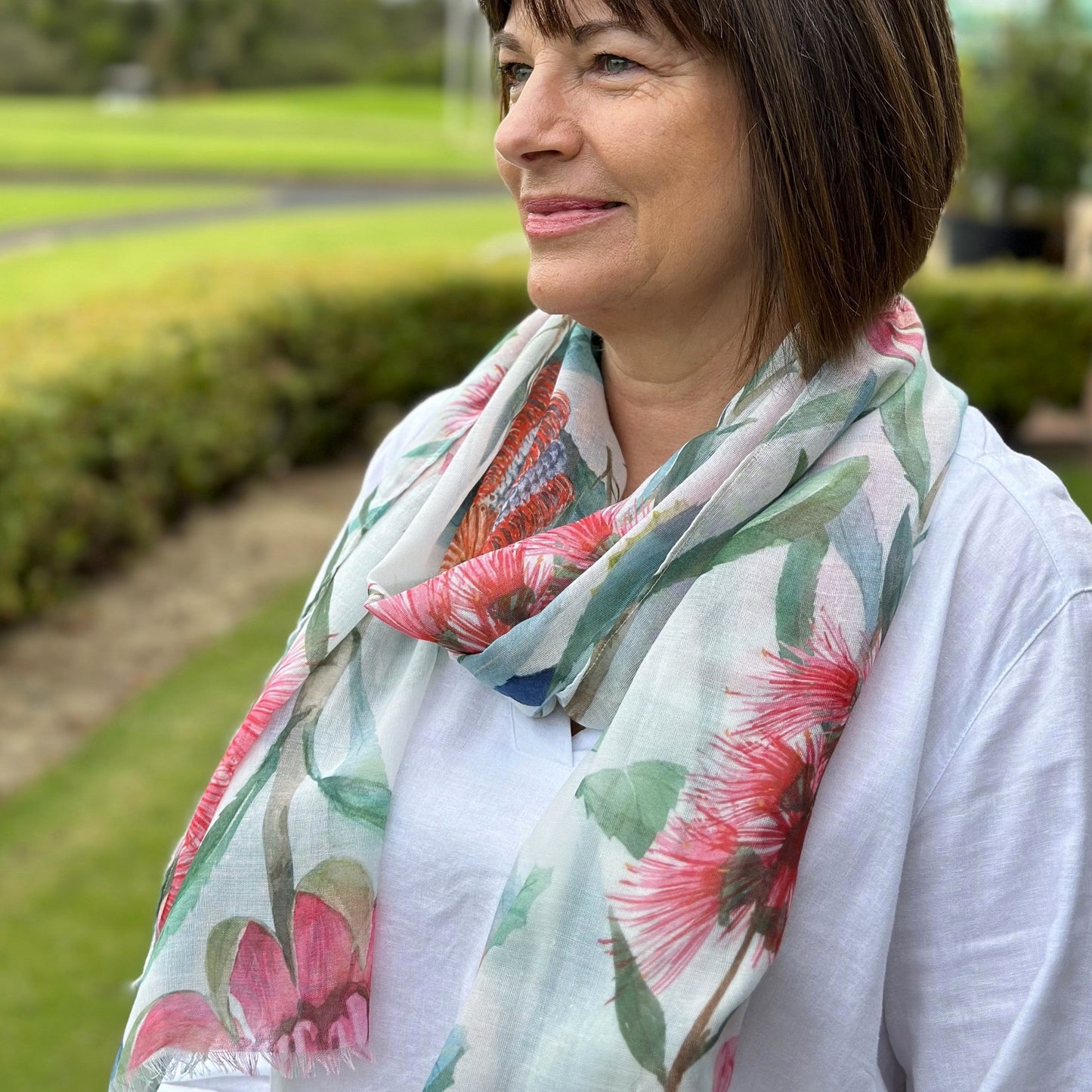 a lady wearing a scarf that has native Australian flowers