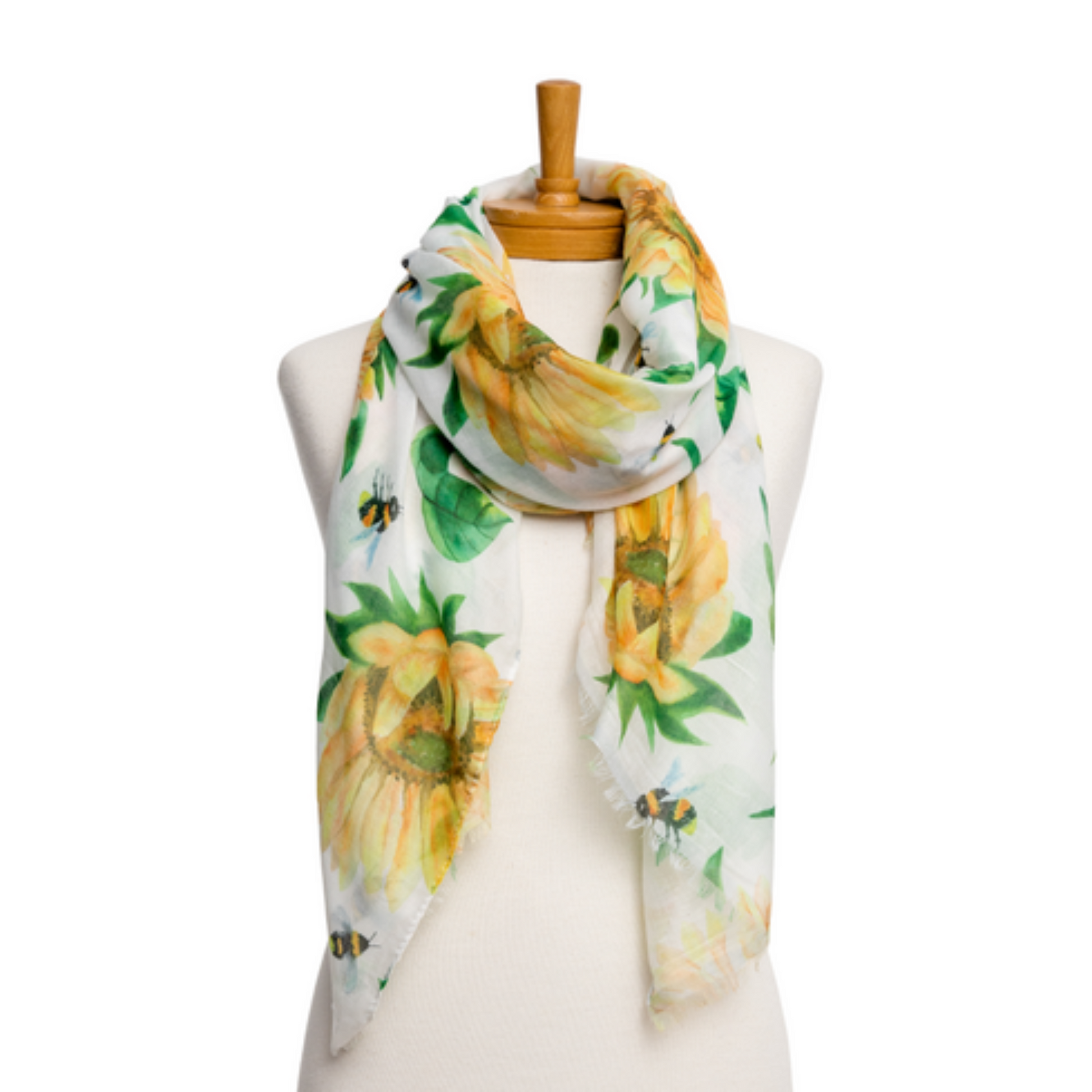 a pretty ladies scarf that has a white background and bright yellow sunflowers, yellow bumble bees and green leaves