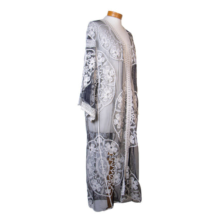 Lace dress on a mannequin against a white background