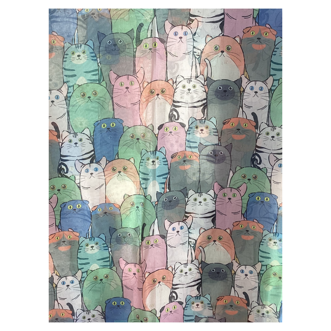 a ladies scarf lying flat so you can see the cute cat pattern. The cats are illustrated in shades of blue, green, apricot and pink.