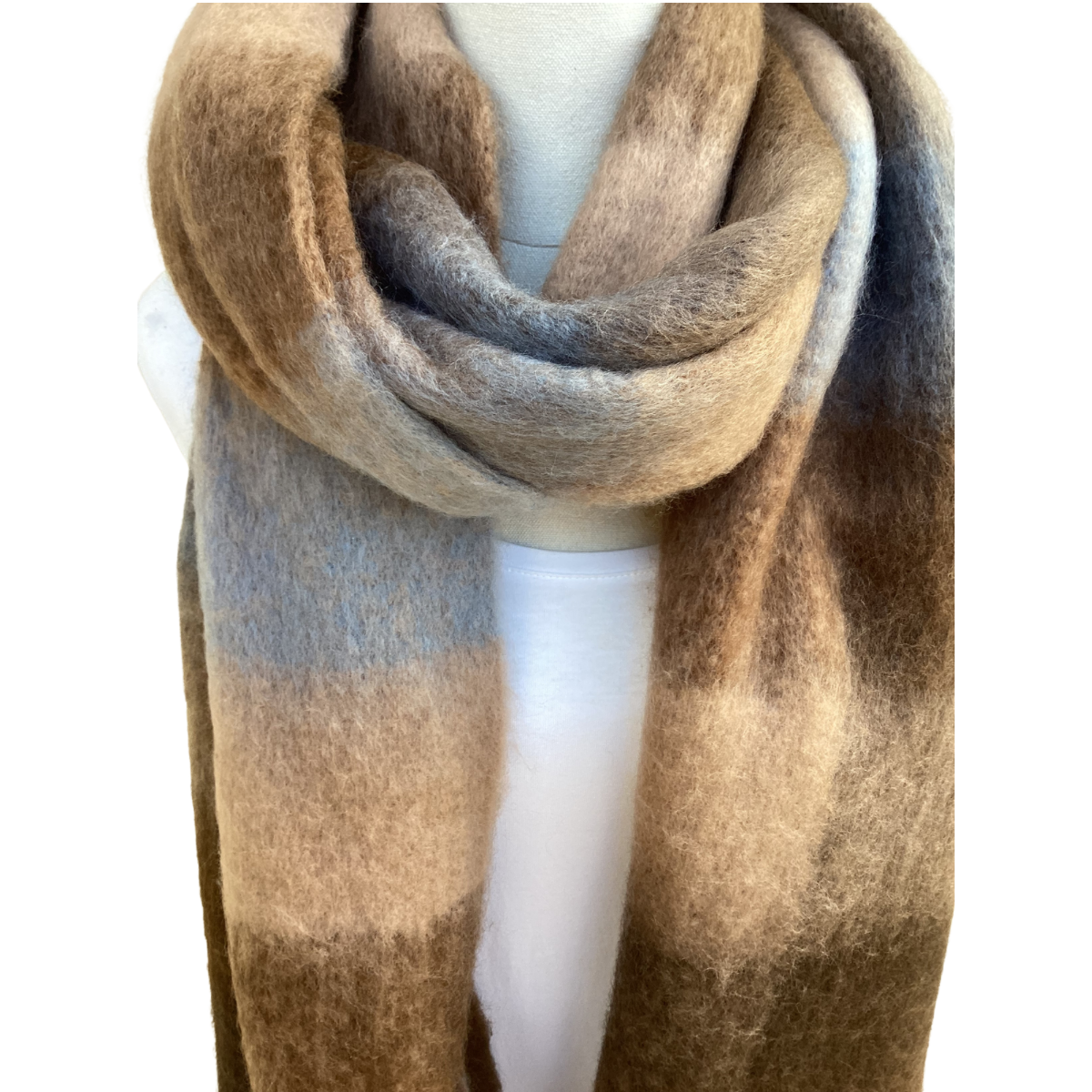 A soft, fuzzy scarf draped on a white mannequin torso, featuring a large-scale checkered pattern in shades of brown, beige, and light gray.