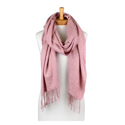 a plain dusty pink coloured scarf that has tassels and is draped around a mannequin. The scarf is very soft and warm.