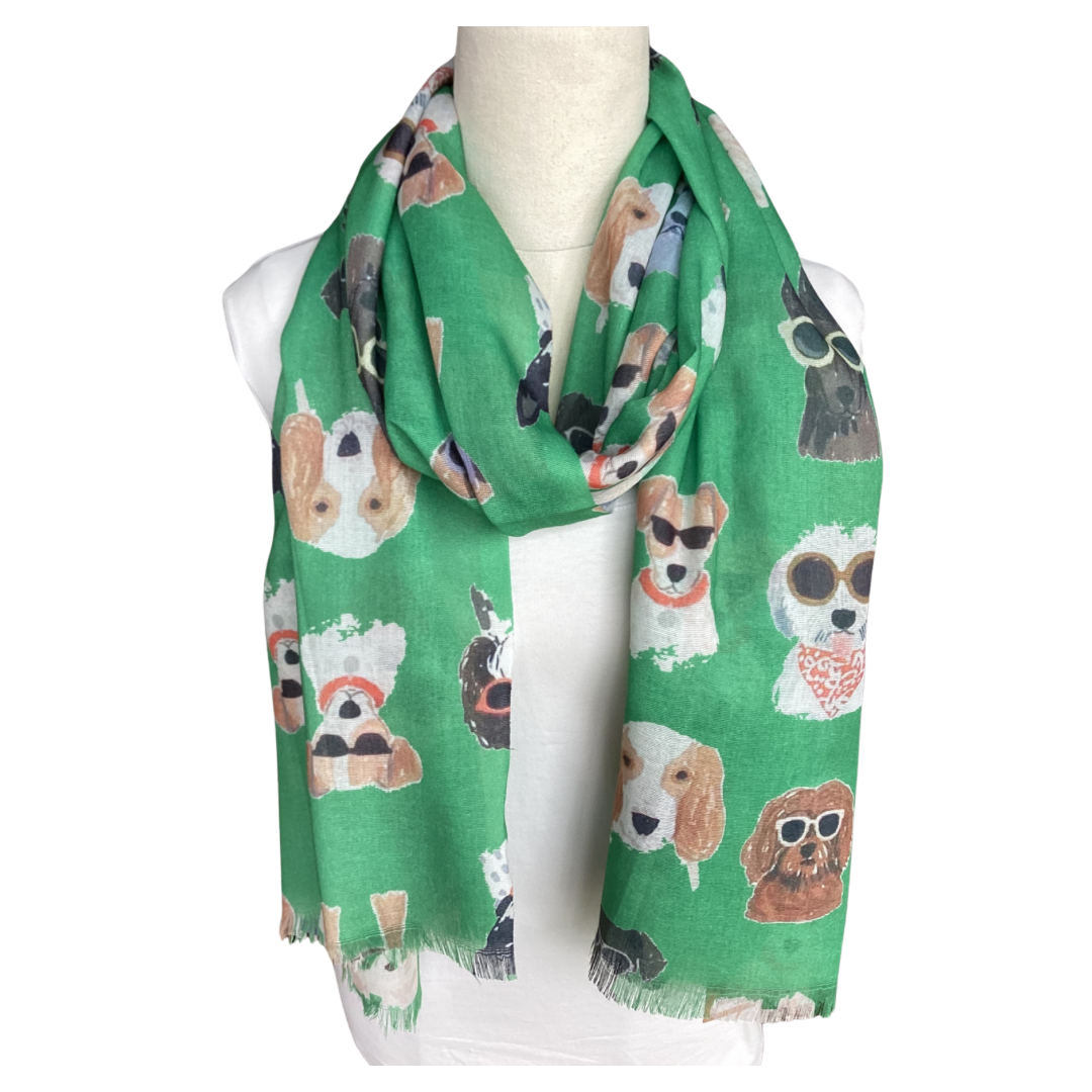 a ladies scarf that has a bright green background and illustrations of cute dog faces