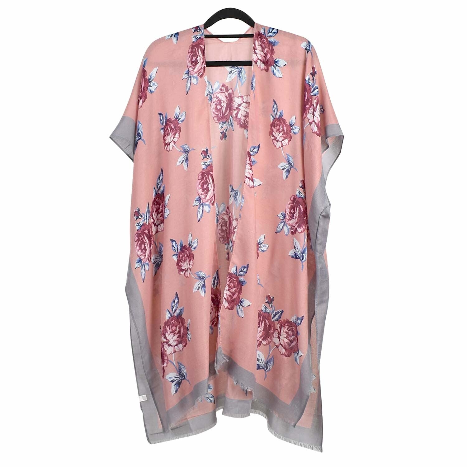 Floral patterned kimono on a hanger against a white background