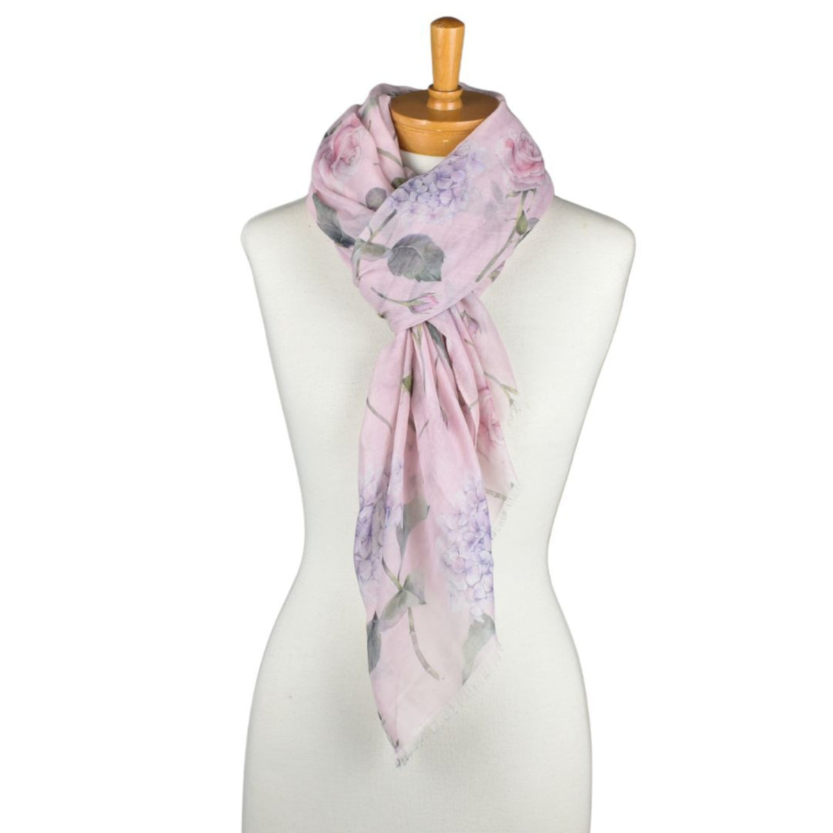 Floral patterned scarf on a mannequin against a white background