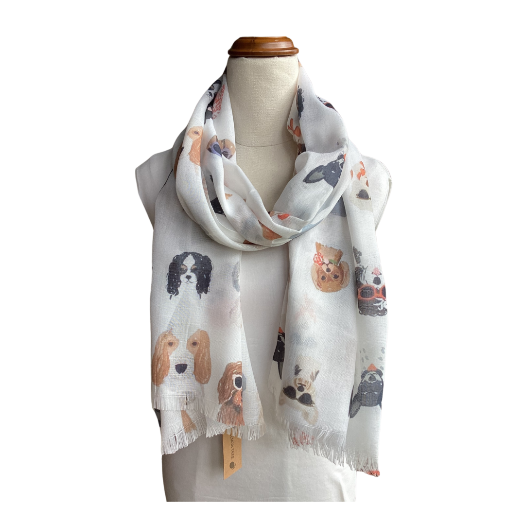 a ladies scarf that has a white background and lots of cute dogs. Some dogs are wearing sunglasses and all of them are very cute