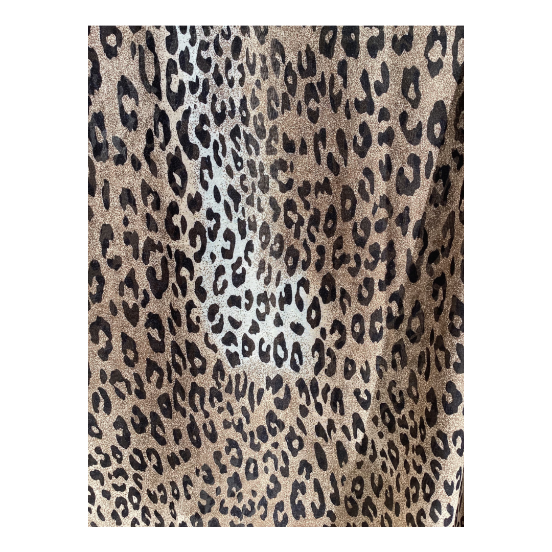 a ladies scarf that shows a black leopard print on a brown and cream background