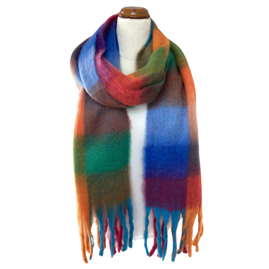 an oversized blanket scarf with a bright check pattern and chunky tassels