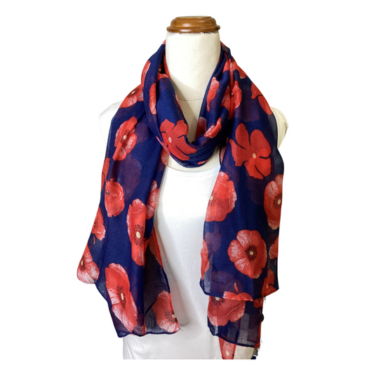 a ladies scarf that has a navy blue background and bright red poppies