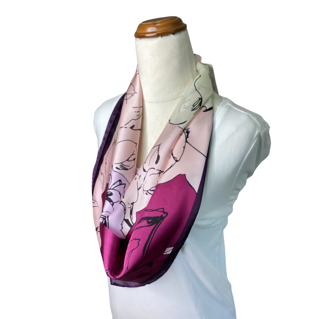 a satin ladies scarf with fuchsia pink and pale pink flowers and a dark purple border