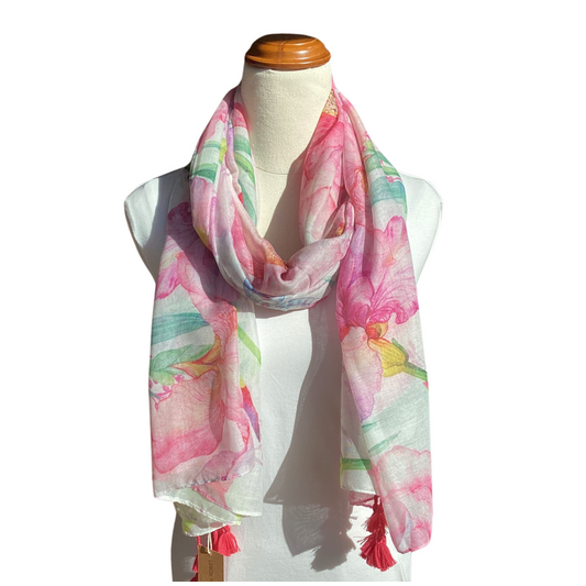 a floral ladies scarf that has bright pink, purple, green and blue flowers.