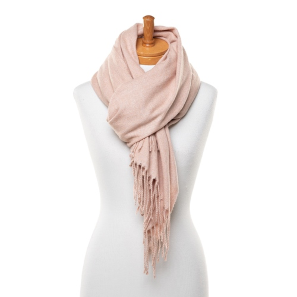 A soft and warm ladies scarf that is plain light red in colour. The scarf is soft and warm and has tassels. The scarf is tied around a mannequin.