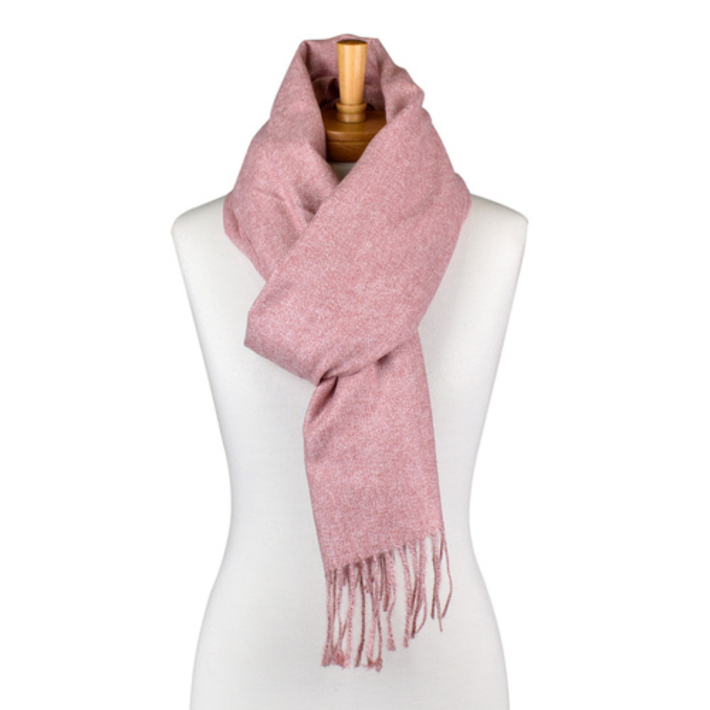 a plain dusty pink coloured scarf that has tassels and is tied around a mannequin. The scarf is very soft and warm.