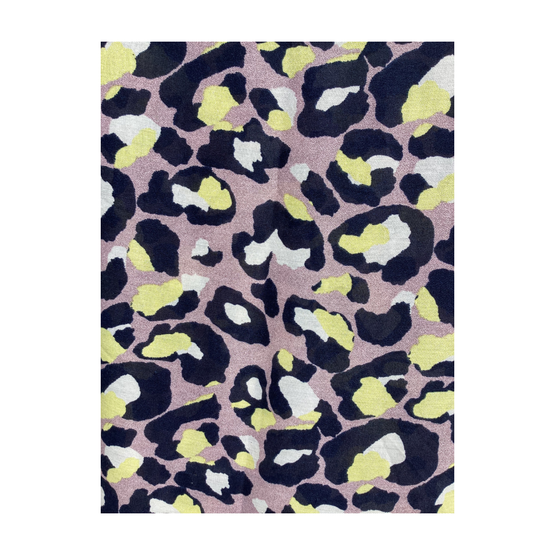 a ladies scarf that has a mottled purple background and large leopard print pattern in colours of navy blue, yellow and white