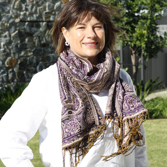 a lady wearing a purple tapestry pashmina shawl with tassles