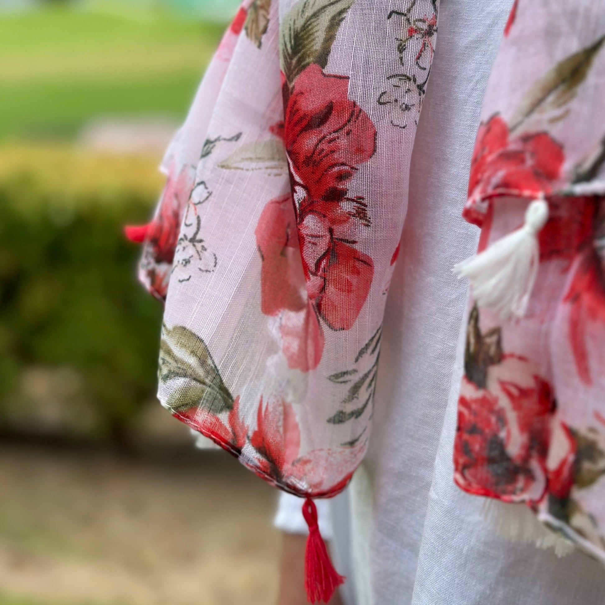 a close up view of the raspberry floral scarf