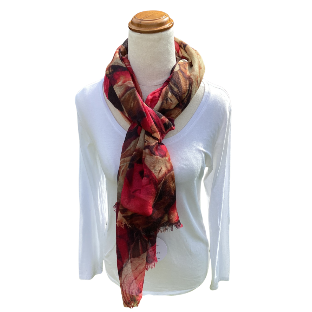 Mannequin wearing a white shirt with a colorful scarf draped over it on a white background