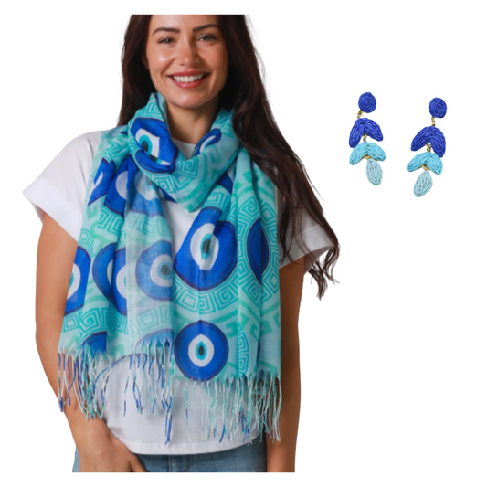 Woman wearing a blue and green patterned scarf with matching earrings on a white background