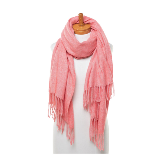 A soft and warm ladies scarf that is plain watermelon pink colour and has tassels. The scarf is very soft and warm and is draped around the neck of a mannequin.